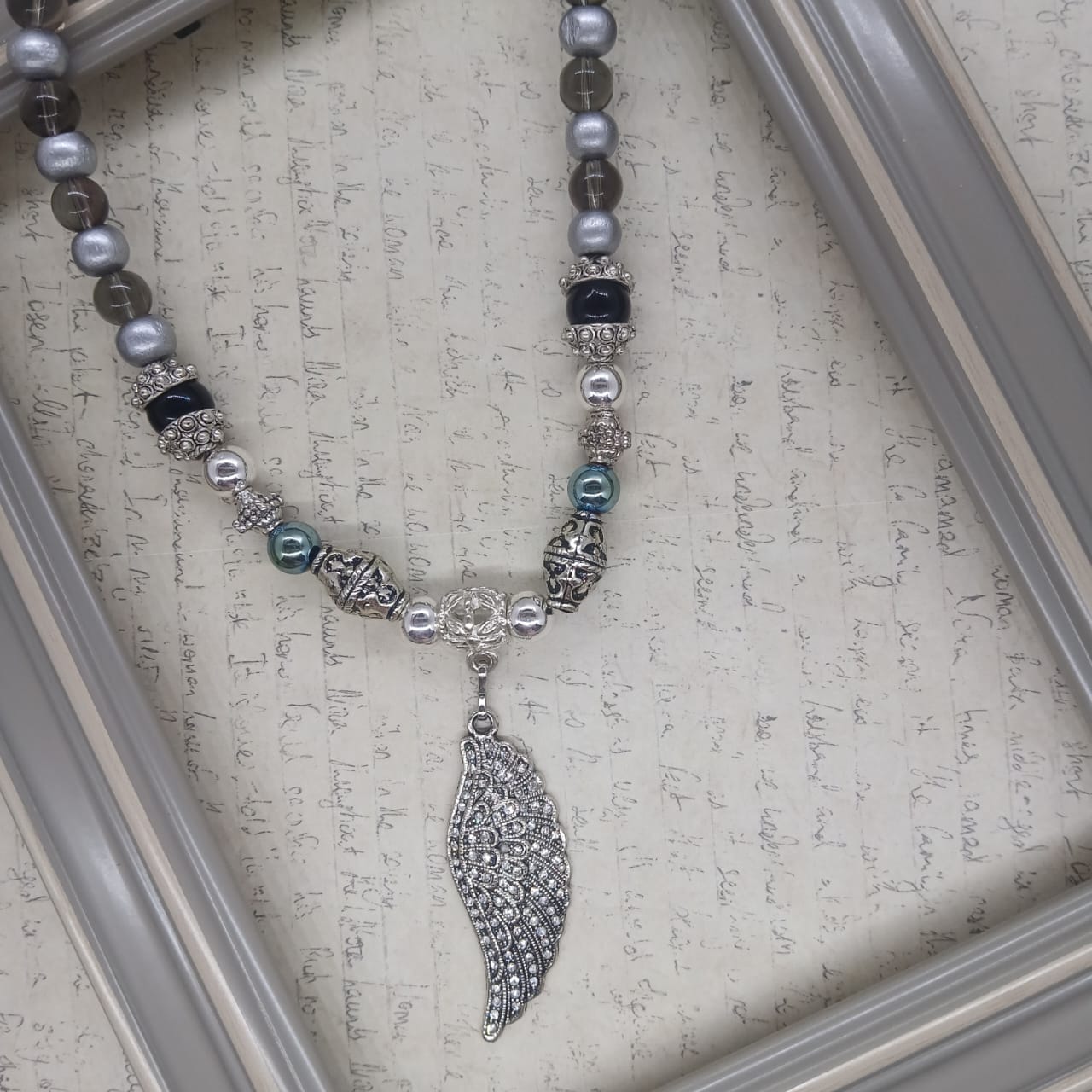 Angel Wing choker silver hematite with glass and wood beads.