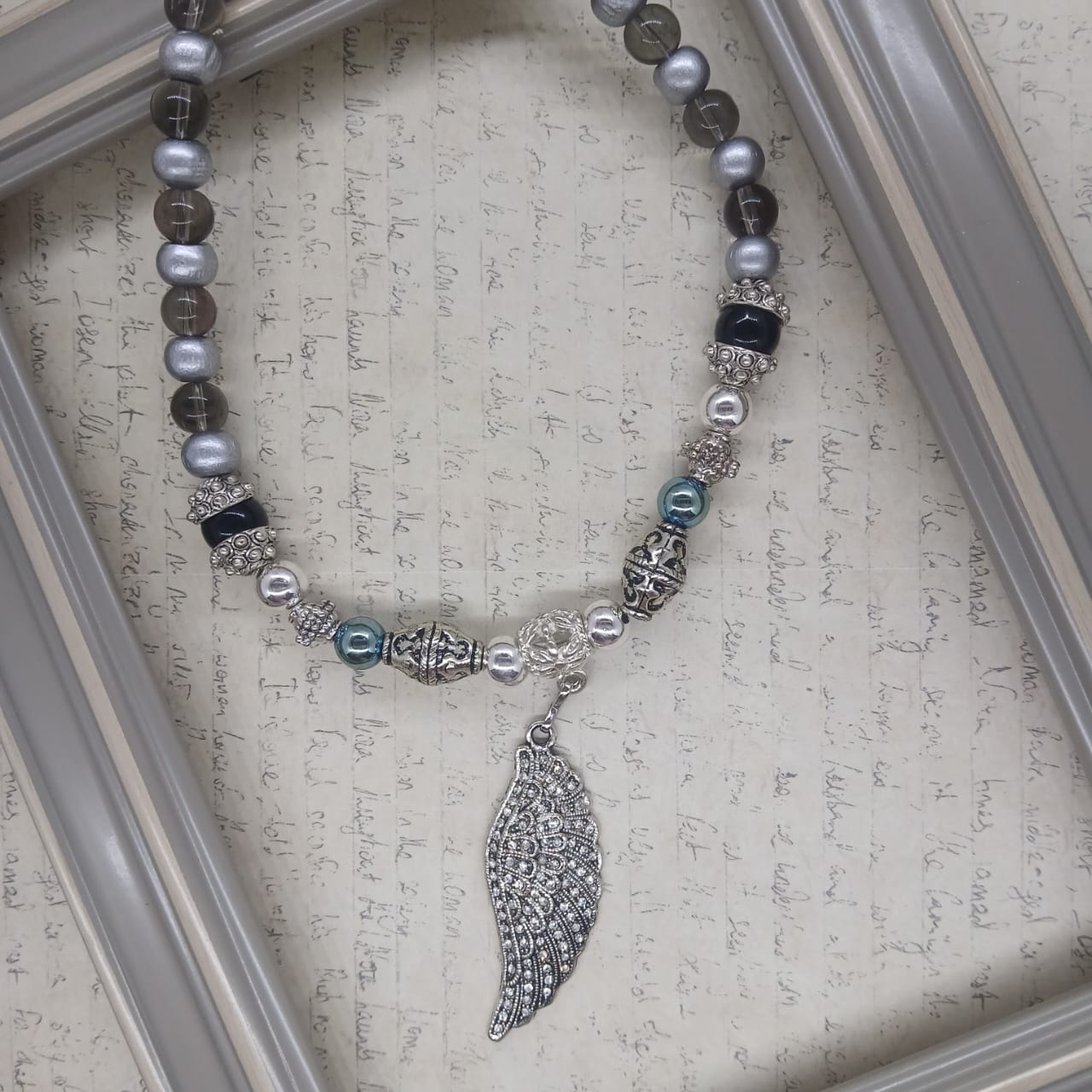 Angel Wing choker silver hematite with glass and wood beads.