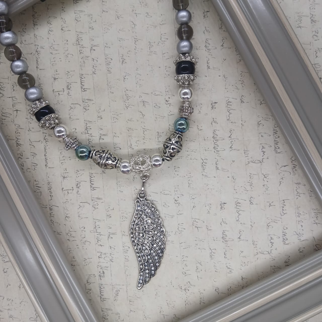 Angel Wing choker silver hematite with glass and wood beads.